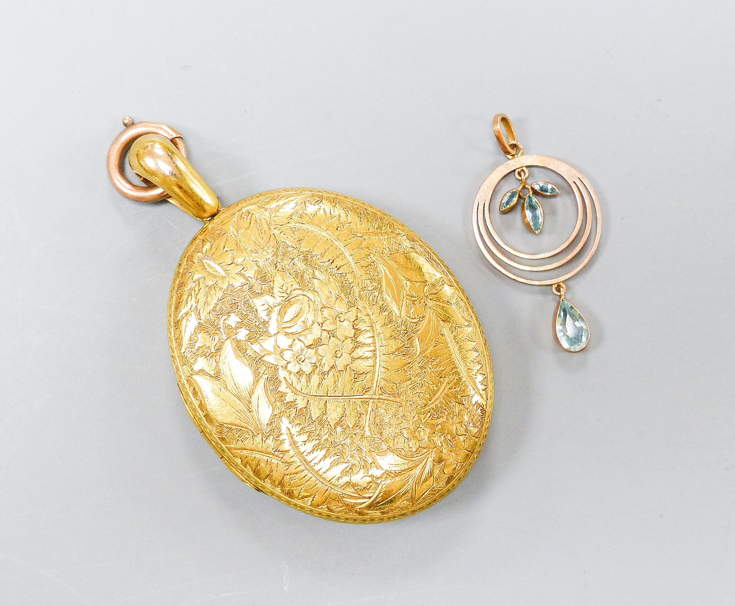 A Victorian engraved yellow metal oval locket, with engraved initials, 47mm, gross 31.6 grams, together with a small yellow metal and gem set pendant, 28mm, gross 1.5 grams.